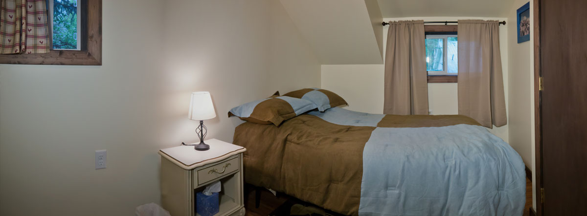 The second bedroom with queen bed and nightstand