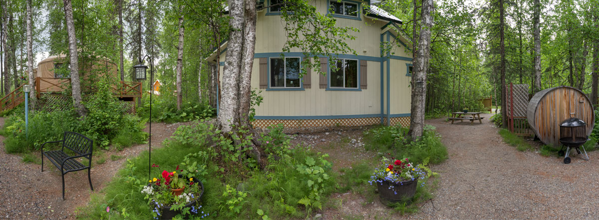 Landscaped area around the cabins with benches and flowers